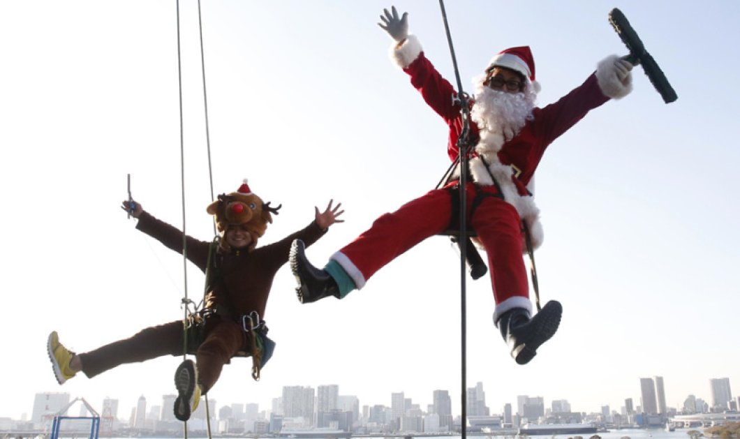 24/12/2014 Καθαριστές παραθύρων ποζάρουν ντυμένοι 'Aγιος Βασίλης και τάρανδος κατά τη διάρκεια χριστουγεννιάτικης εκδήλωσης σε εμπορικό κέντρο στο Τόκιο Picture: REUTERS/Yuya Shino