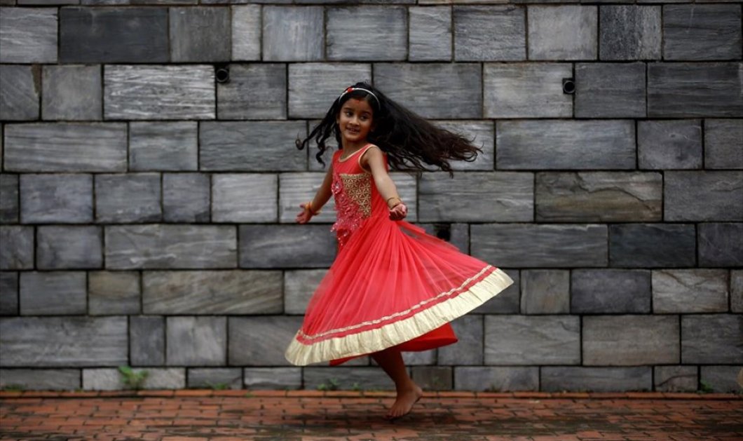 'Ενα μικρό κορίτσι παίζει έξω από τον Ναό Πασουπατινάθ , κατά τη διάρκεια του θρησκευτικού φεστιβάλ Teej, στο Κατμαντού - Picture: REUTERS / NAVESH CHITRAKAR 