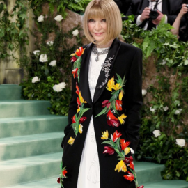 Anna Wintour: Η οικοδέσποινα του Met Gala με μαύρο maxi coat & διάσπαρτα πολύχρωμα λουλούδια – Το λευκό φόρεμα & το iconic καρέ χτένισμα (φωτό & βίντεο)